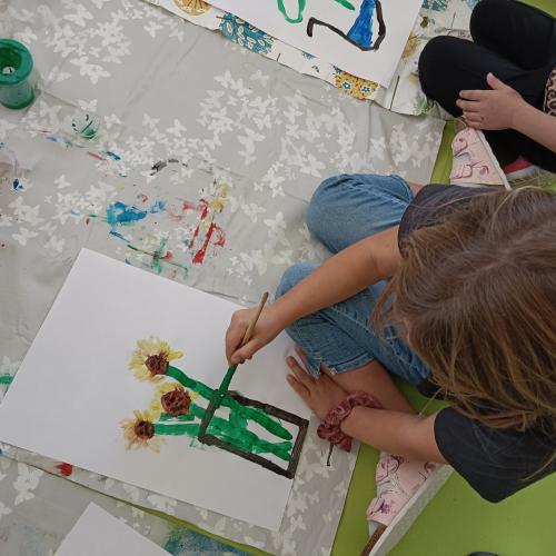 Kind beim Malen einer Sonnenblume 